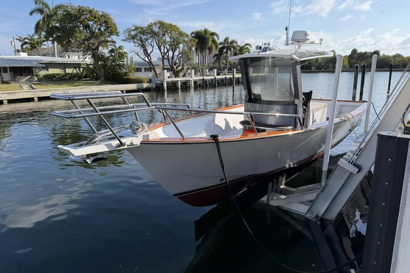 Slide: The Image of Custom 2013 Jet Center Console boat docked by waterfront homes. - 4