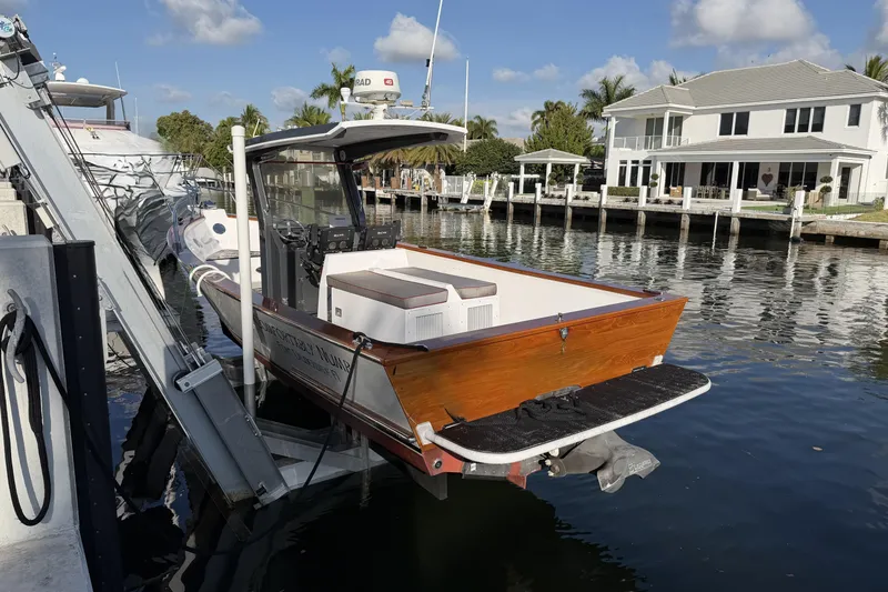 Slide: The Image of Custom 2013 Jet Center Console boat docked by waterfront home, clear sky. - 5