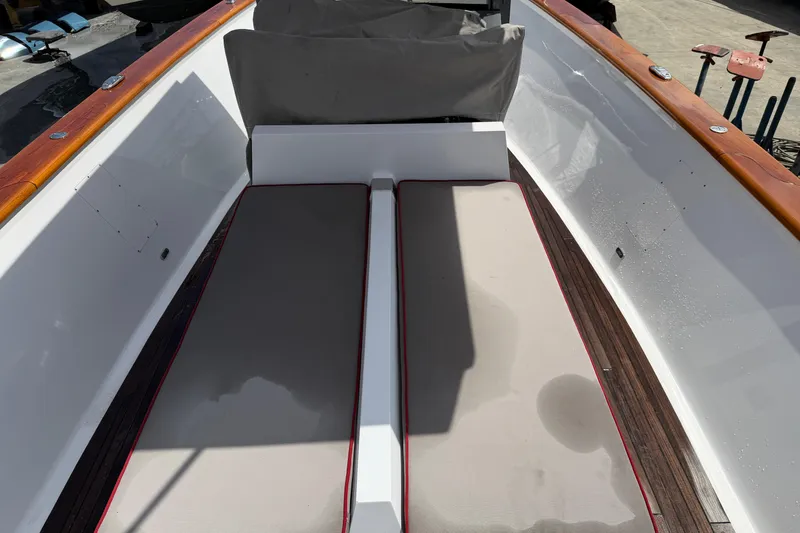 Slide: The Image of 2013 Custom Jet Center Console boat interior with cushioned seating and wooden accents. - 6