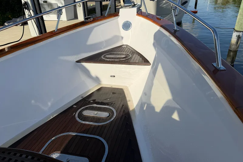 Slide: The Image of Custom 2013 Jet Center Console boat interior with wooden deck and stainless steel railings. - 9