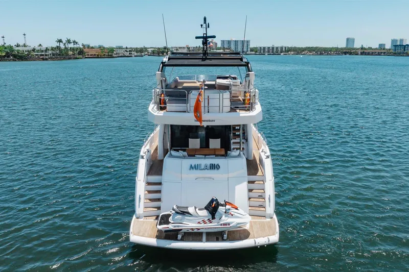 Slide: The Image of 2022 Sunseeker 76 Yacht on water, rear view with jet ski onboard. - 10