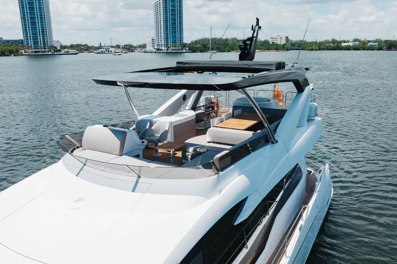 Slide: The Image of 2022 Sunseeker 76 Yacht on water, featuring spacious deck and modern design. - 12