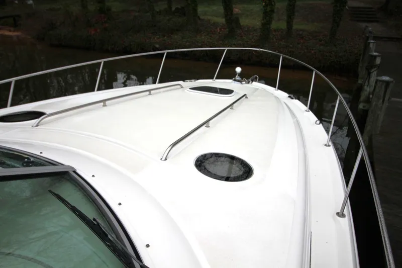 Slide: The Image of 2004 Sea Ray 340 Sundancer boat deck with railings and portholes. - 11