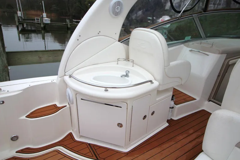 Slide: The Image of 2004 Sea Ray 340 Sundancer boat interior with sink and seating on teak deck. - 17