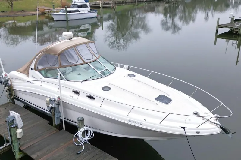 Slide: The Image of 2004 Sea Ray 340 Sundancer docked in a serene marina setting. - 2