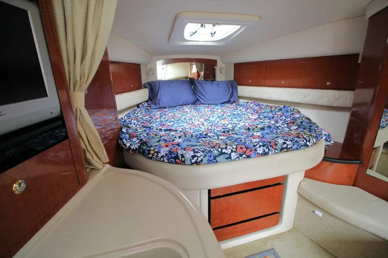 Slide: The Image of Luxurious 2004 Sea Ray 340 Sundancer cabin with cozy bed and floral bedding. - 23