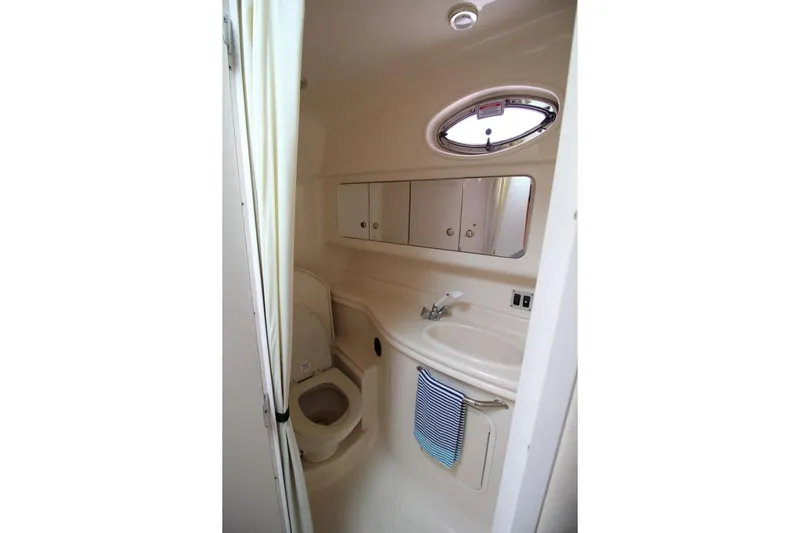 Slide: The Image of Bathroom interior of 2004 Sea Ray 340 Sundancer yacht, featuring sink and toilet. - 25
