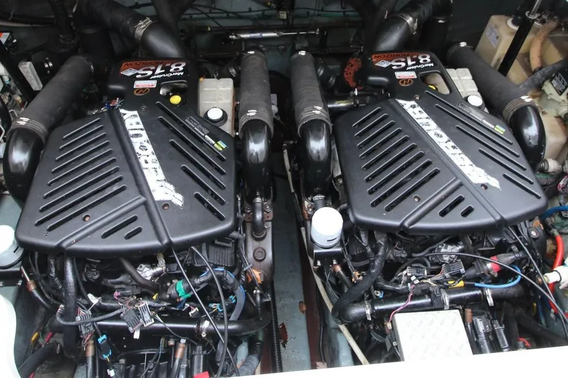 Slide: The Image of Twin engines of a 2004 Sea Ray 340 Sundancer boat, showcasing powerful marine machinery. - 26