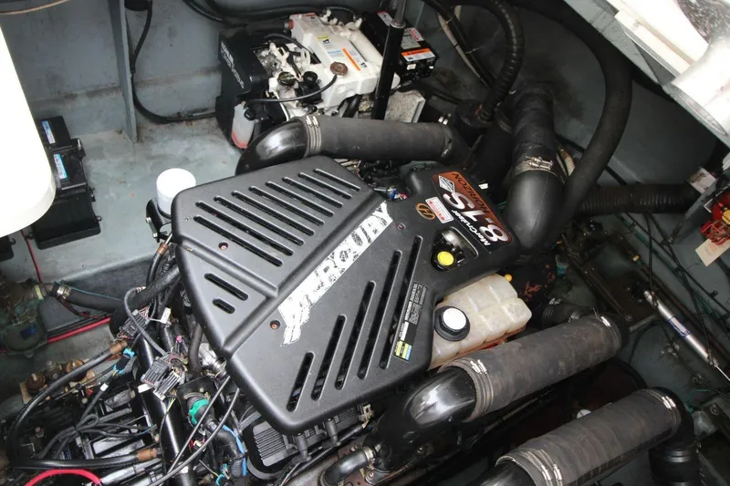 Slide: The Image of Engine compartment of a 2004 Sea Ray 340 Sundancer boat, showcasing mechanical components. - 28
