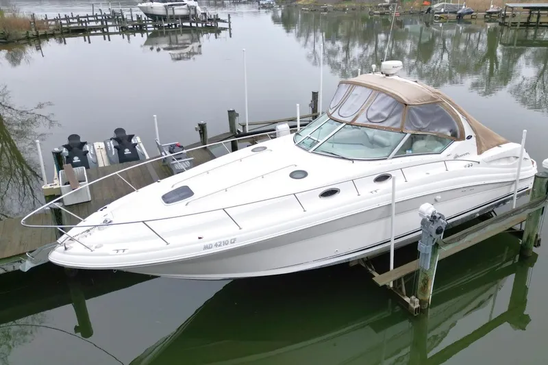 Slide: The Image of 2004 Sea Ray 340 Sundancer docked in a serene marina setting. - 3