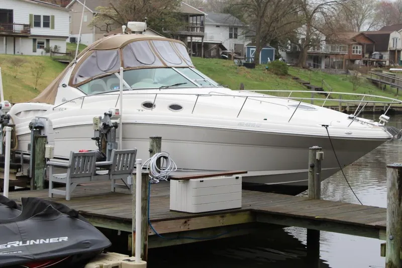 Slide: The Image of 2004 Sea Ray 340 Sundancer docked by waterfront homes. - 4