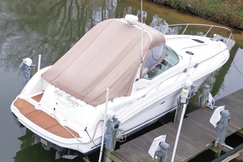 Slide: The Image of 2004 Sea Ray 340 Sundancer docked with beige canopy cover. - 9