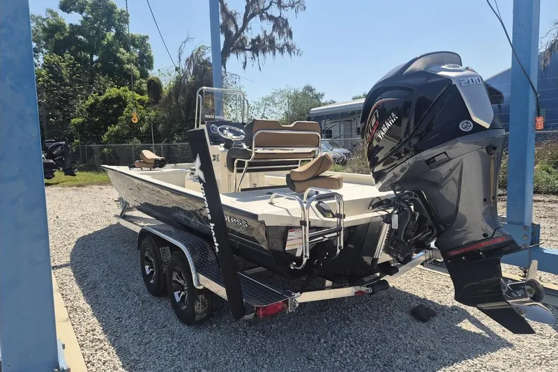 The Image of 2026 Xpress H24B Bay boat with Yamaha outboard motor on trailer. - 1