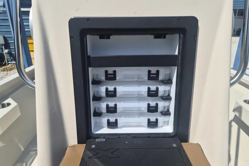 Slide: The Image of Storage compartment with tackle boxes on a 2026 Xpress H24B Bay boat. - 10