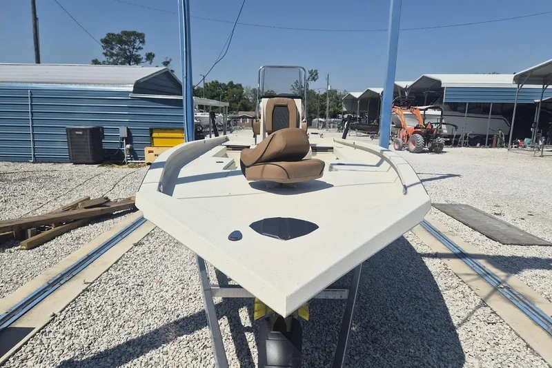 Slide: The Image of 2026 Xpress H24B Bay boat on trailer in outdoor storage area. - 3