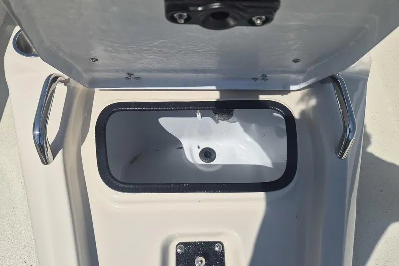 Slide: The Image of Open storage compartment on 2026 Xpress H24B Bay boat with stainless steel handles. - 9