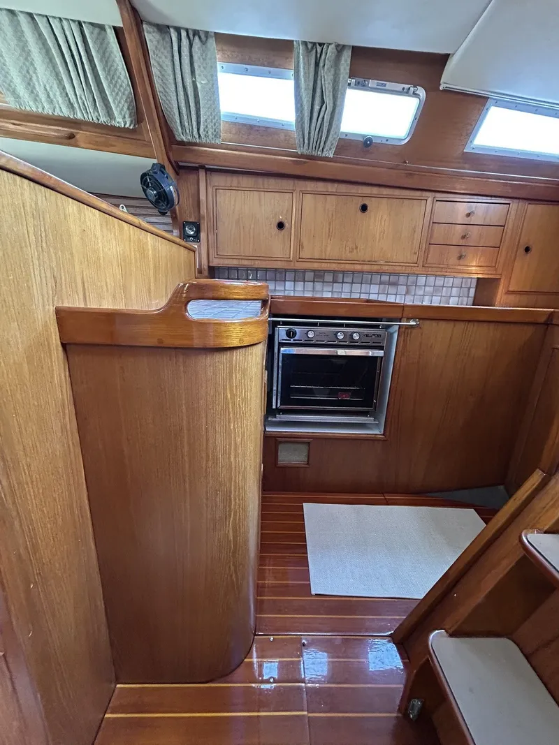 Slide: The Image of Interior of a 1987 Wauquiez Centurion yacht with wooden cabinetry. - 15