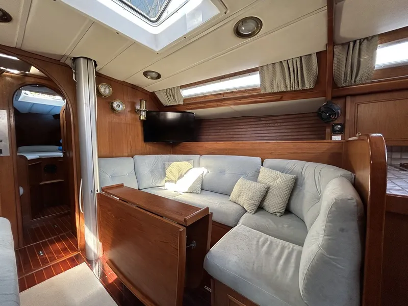 Slide: The Image of Interior of a 1987 Wauquiez Centurion yacht with cozy seating area. - 18