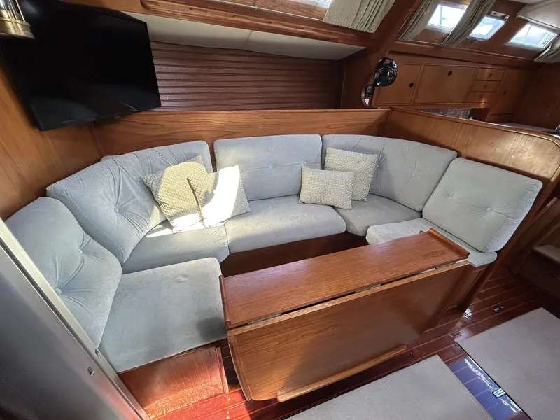 Slide: The Image of Interior of a 1987 Wauquiez Centurion yacht with cozy seating area. - 19