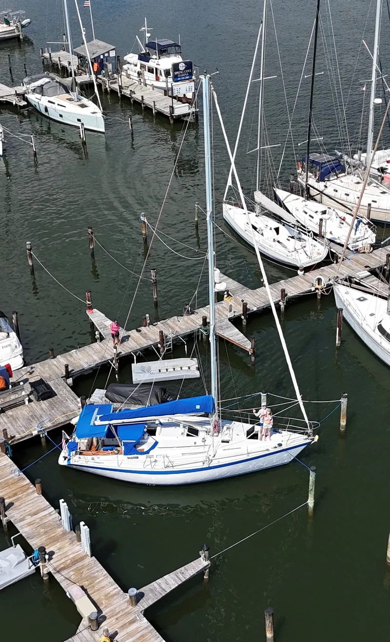Slide: The Image of Aerial view of a 1987 Wauquiez Centurion sailboat docked in a marina. - 2