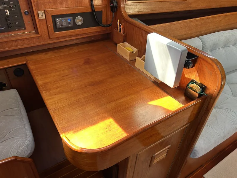 Slide: The Image of Interior of a 1987 Wauquiez Centurion with wooden desk and navigation equipment. - 23