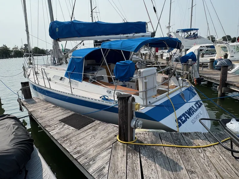 Slide: The Image of 1987 Wauquiez Centurion sailboat docked at marina. - 6