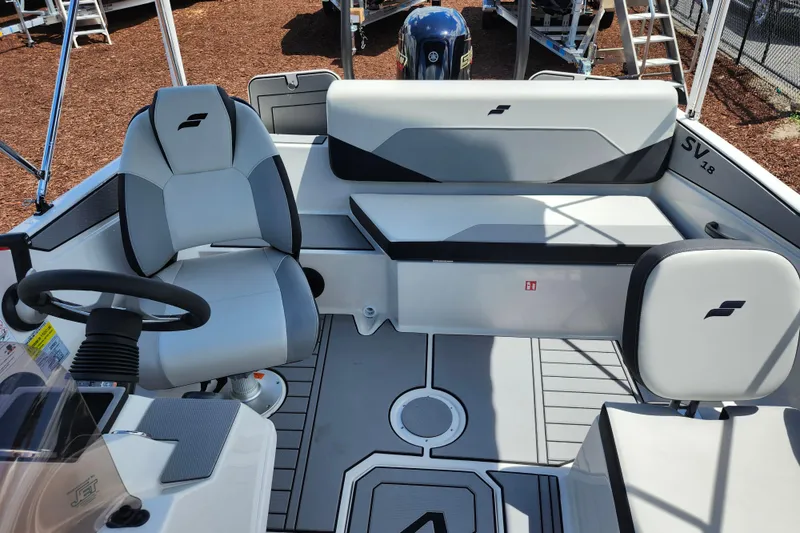 Slide: The Image of 2026 Starcraft SV 18 OB boat interior with modern seating and steering wheel. - 14