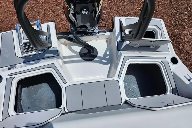 Slide: The Image of 2026 Starcraft SV 18 OB boat stern with storage compartments and motor. - 16