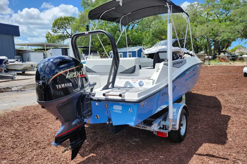 Slide: The Image of 2026 Starcraft SV 18 OB boat with Yamaha engine on trailer, parked outdoors. - 7