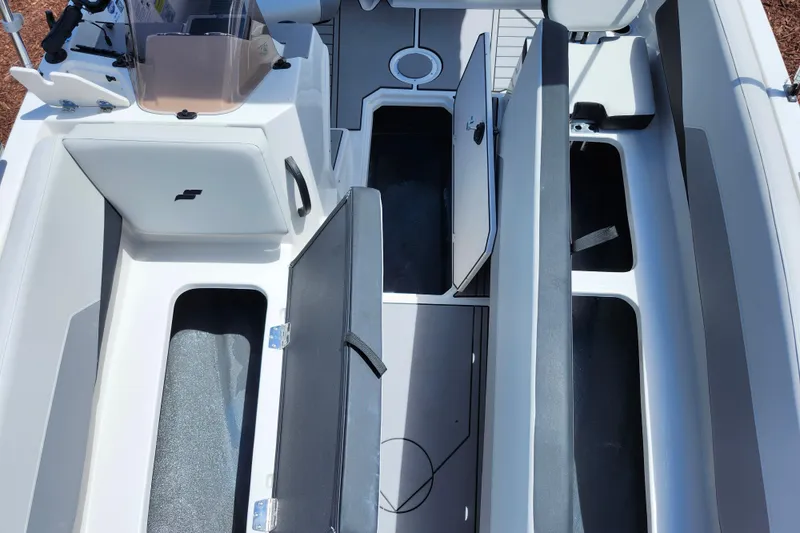 Slide: The Image of 2026 Starcraft SV 18 OB boat interior with open storage compartments and seating. - 8