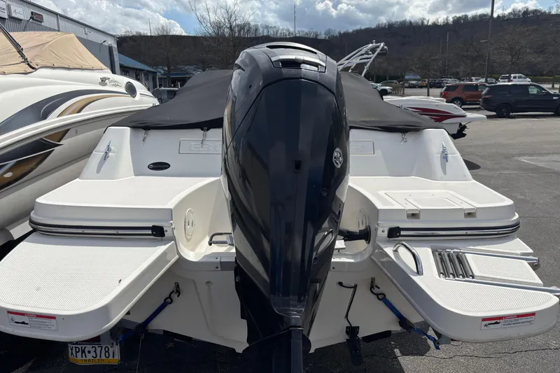 Slide: The Image of 2018 Bayliner 180 Bowrider with outboard motor, parked outdoors. - 4