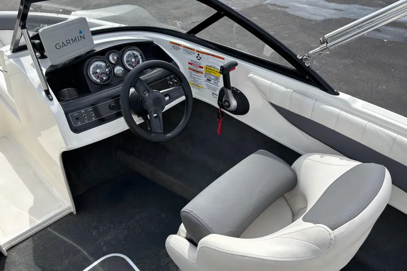 Slide: The Image of 2018 Bayliner 180 Bowrider cockpit with Garmin navigation, steering wheel, and control panel. - 7