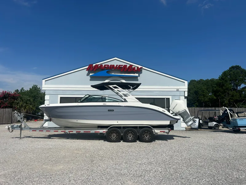 Slide: The Image of A 2027 Sea Ray 270SD-OB boat on a trailer in front of a MarineMax building. - 1