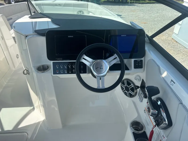 Slide: The Image of The image shows the cockpit of a Sea Ray 270SD-OB boat with modern instruments. - 19