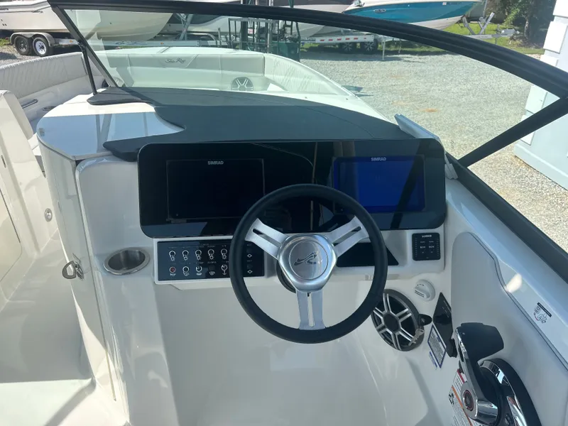 Slide: The Image of The image shows the helm of a Sea Ray 270SD-OB boat with modern instruments. - 20