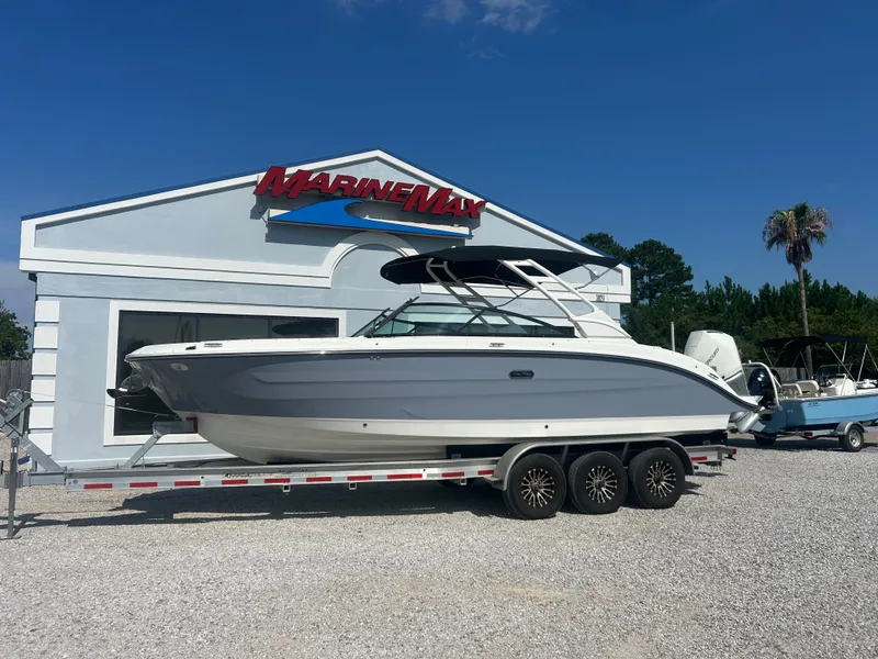 Slide: The Image of A 2027 Sea Ray 270SD-OB boat on a trailer in front of a MarineMax building. - 2