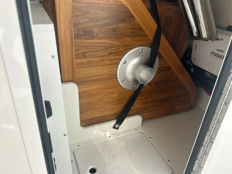 Slide: The Image of Interior view of a boat with a wooden table and safety strap. - 12