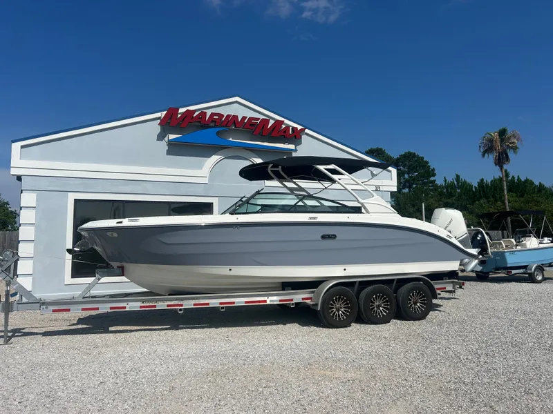 Slide: The Image of A 2027 Sea Ray 270SD-OB boat on a trailer in front of a MarineMax building. - 3