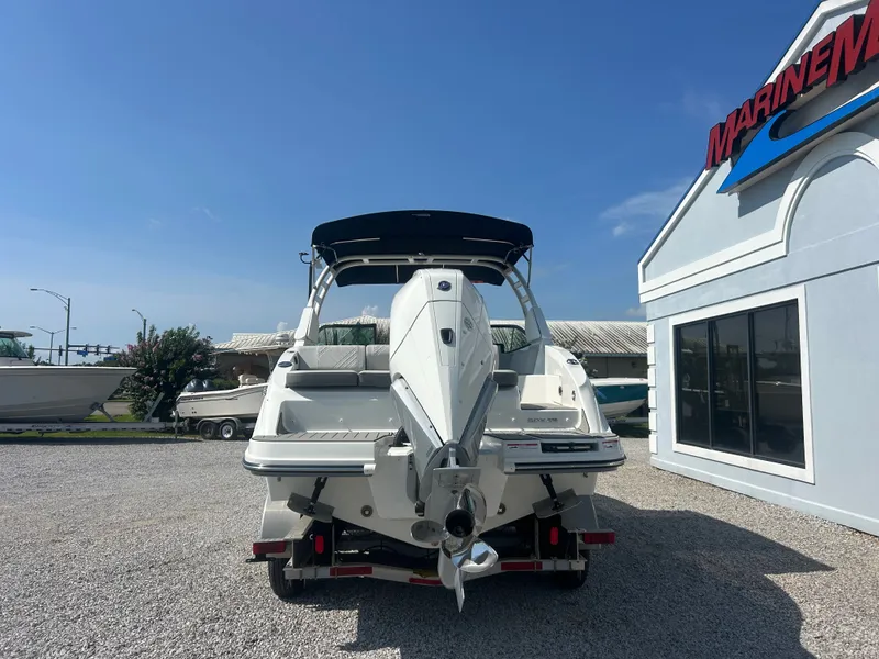 Slide: The Image of The image shows a Sea Ray 270SD-OB boat on a trailer, parked on a gravel lot. - 6