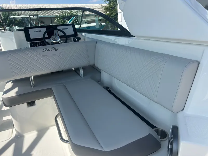 Slide: The Image of The image shows the cockpit of a Sea Ray 270SD-OB boat with gray upholstery and modern instruments. - 8