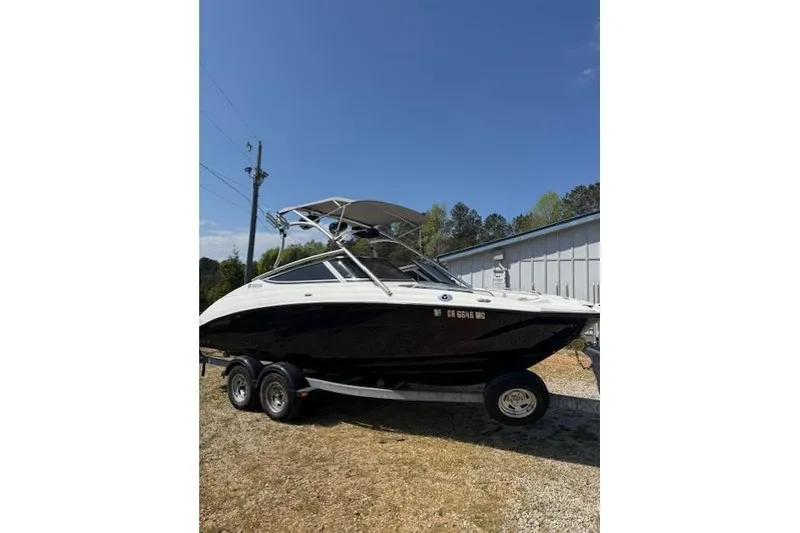 The Image of 2012 Yamaha AR210 boat on trailer under clear blue sky. - 1