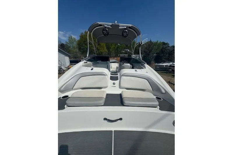 Slide: The Image of 2012 Yamaha AR210 boat with seating and canopy under clear blue sky. - 3