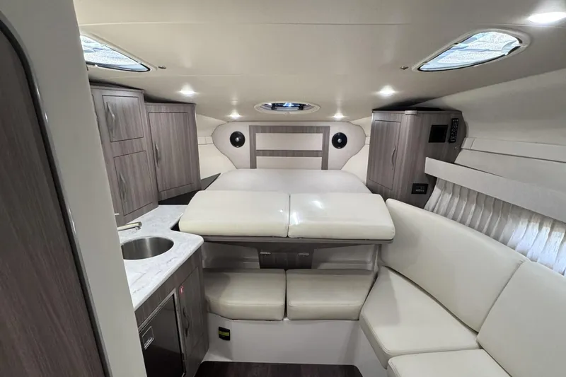 Slide: The Image of Luxurious interior of a 2020 Regal 33 XO yacht with modern cabinetry and seating. - 14