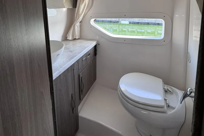 Slide: The Image of 2020 Regal 33 XO boat bathroom with modern fixtures and window view. - 19