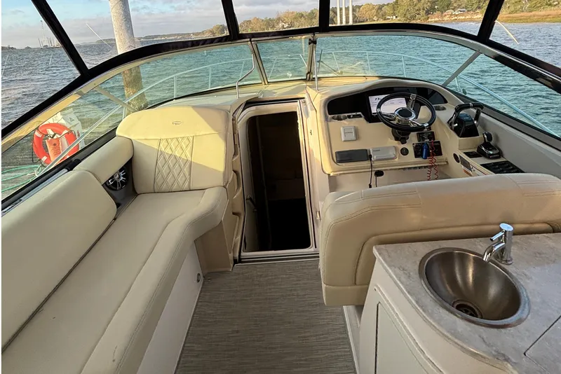 Slide: The Image of Interior of a 2020 Regal 33 XO boat with helm and seating area. - 3