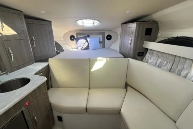 Slide: The Image of 2020 Regal 33 XO yacht interior with bed, seating, and cabinetry. - 4
