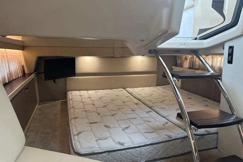Slide: The Image of Interior cabin of 2020 Regal 33 XO yacht with bed and TV. - 7