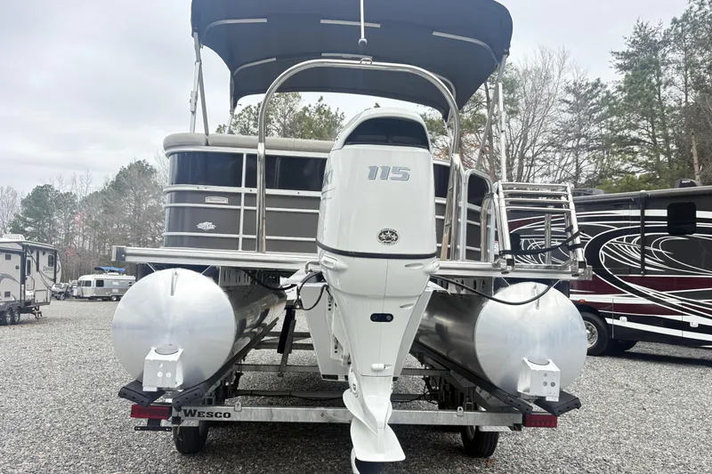 Slide: The Image of 2022 South Bay LE pontoon boat with 115 horsepower engine on a trailer. - 10