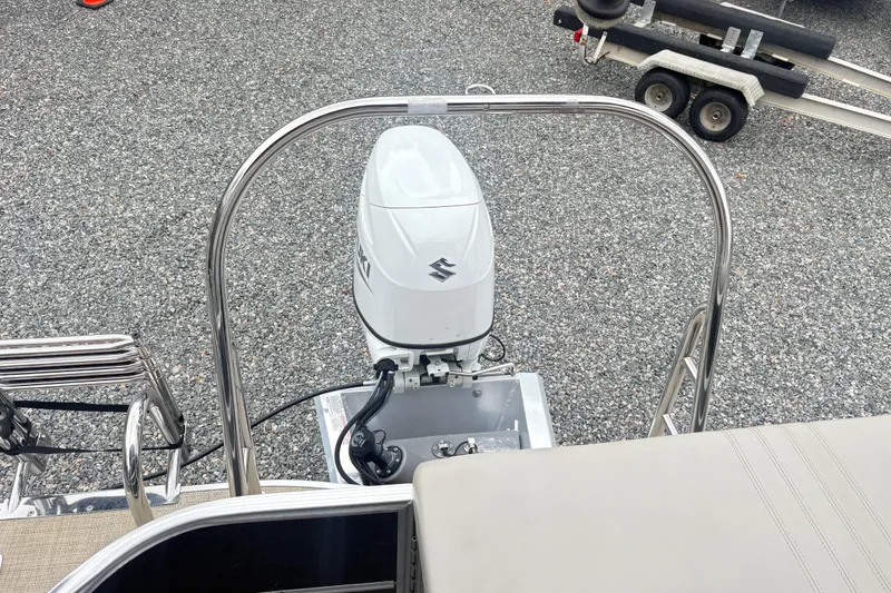 Slide: The Image of 2022 South Bay LE boat with Suzuki outboard motor and trailer on gravel surface. - 11