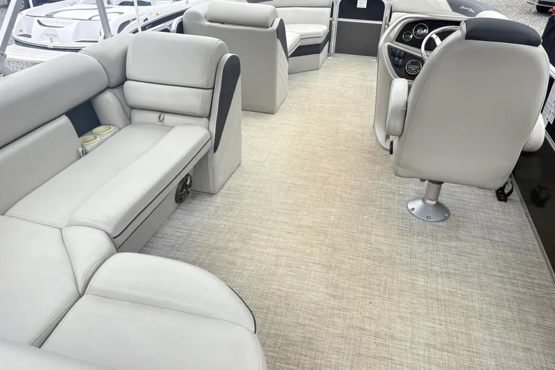 Slide: The Image of Interior of a 2022 South Bay LE boat with plush seating and modern dashboard. - 12
